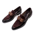 Men's black leather shoes with patent leather finish and a decorative tassel on the front.