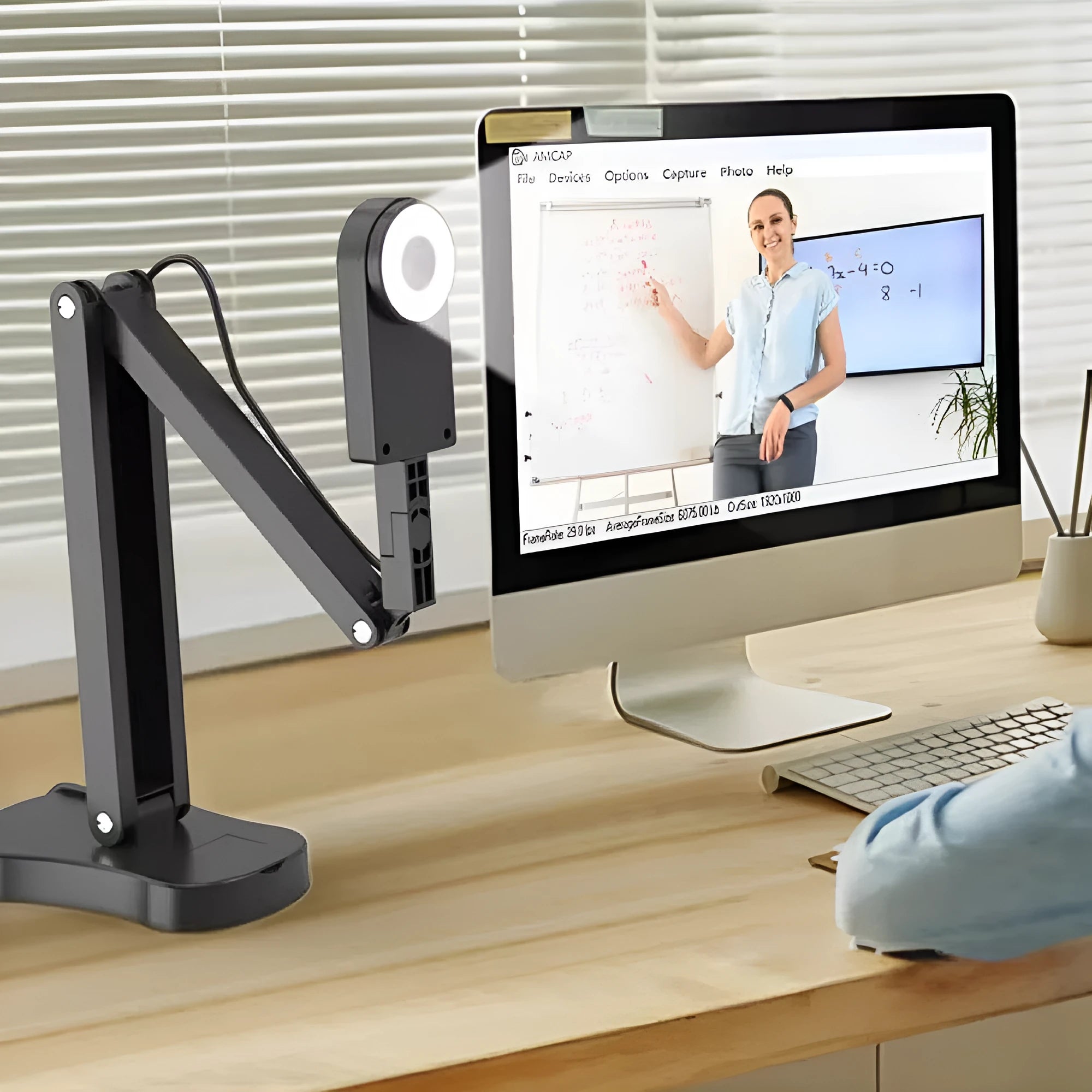 Computer webcam with microphone showing USB cable connection and lens detail