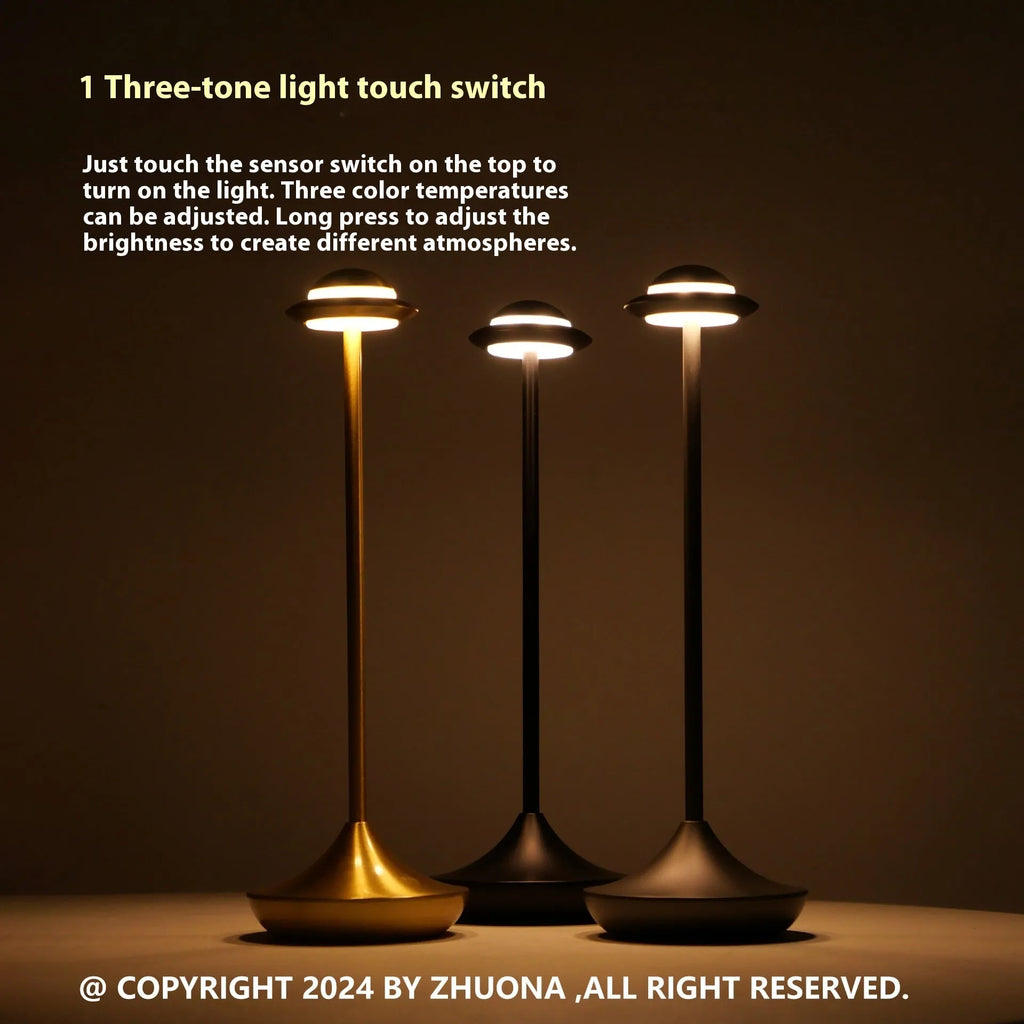 Creative UFO-shaped rechargeable table lamp with metal base in black, gold, or grey colour.
