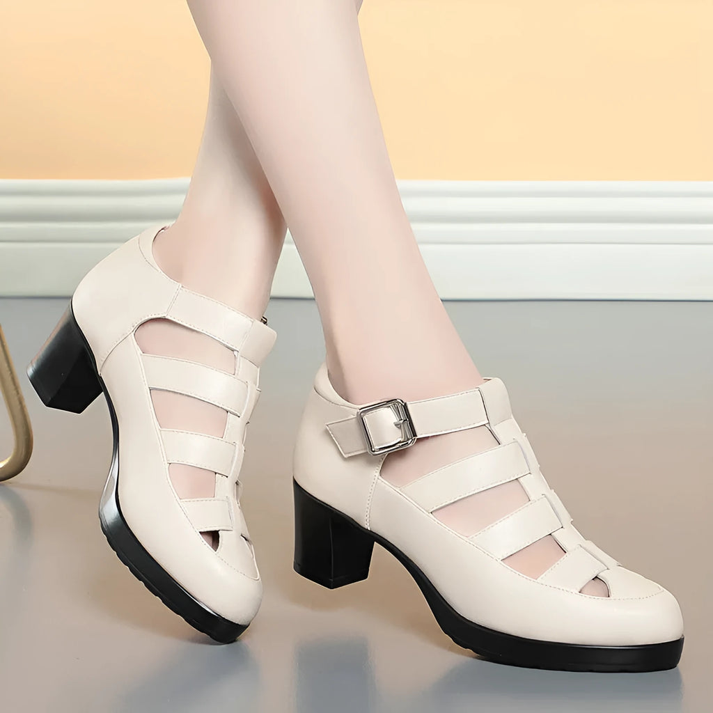 Women's beige closed toe sandals with a chunky heel, woven ankle strap, and back zipper.