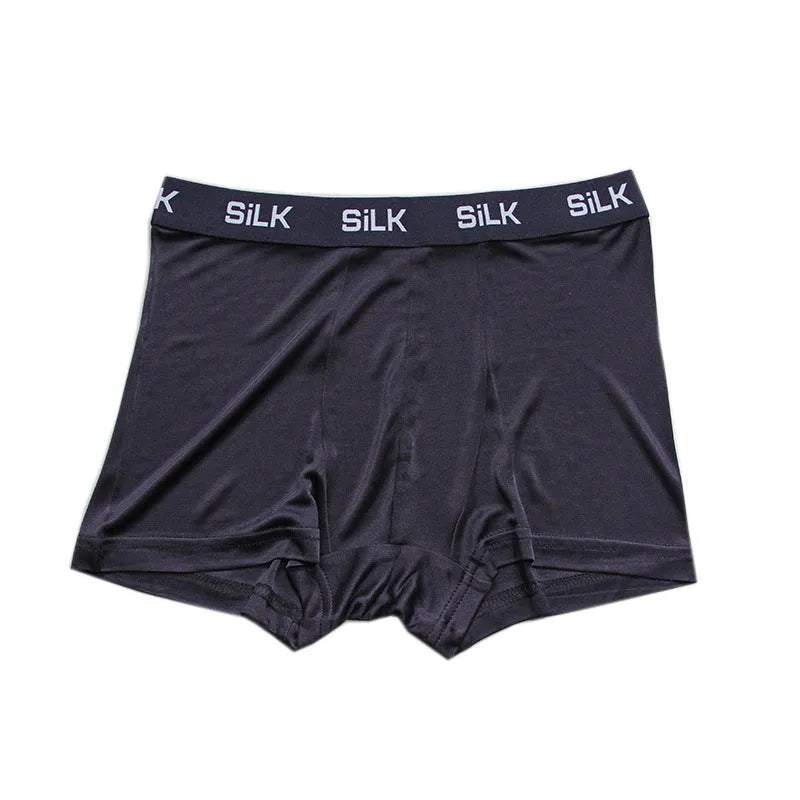 Men's loose-fitting silk shorts in navy blue, shown on a mid-waist, highlighting the breathable casual design.