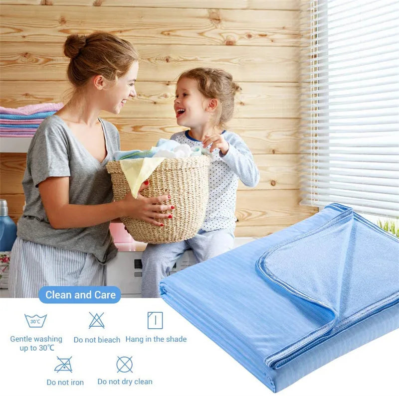 Blue cooling blanket with double-faced texture on a bed, showing its lightweight drape.