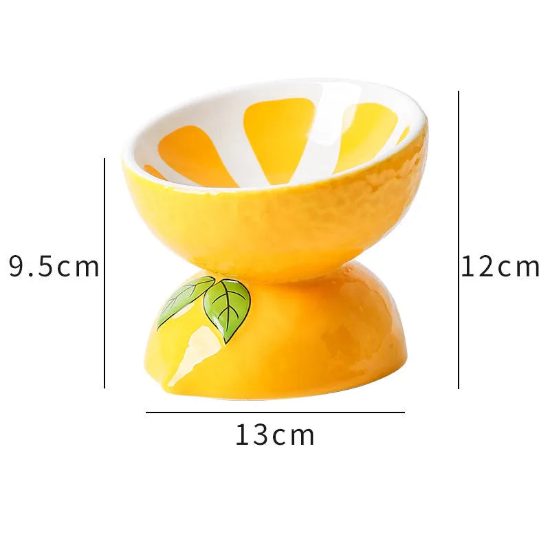 Ceramic tilted and elevated cat food bowl in orange pattern with non-slip base.