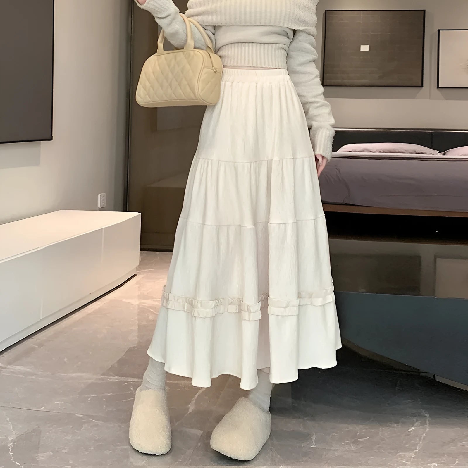 Beige corduroy A-line midi skirt with elastic waistband shown on mannequin