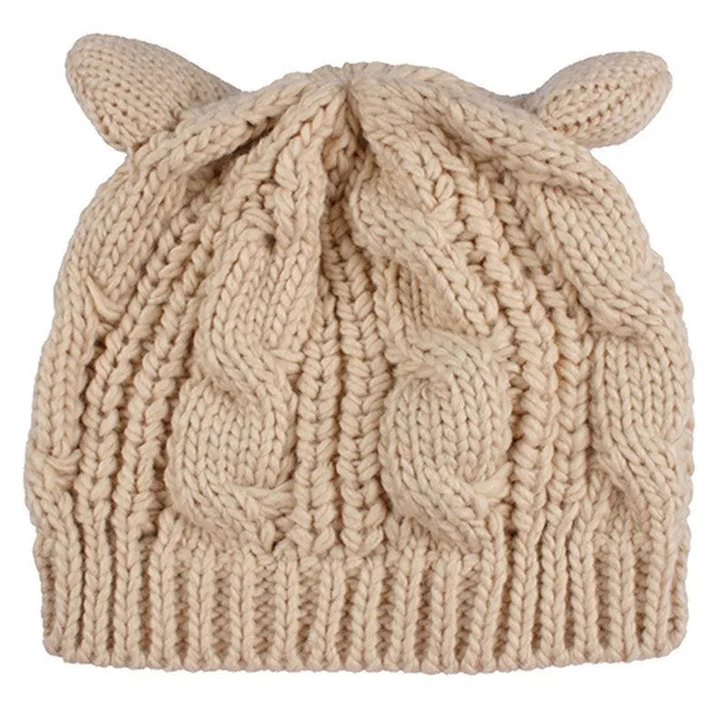 Hand-knitted red wool beanie with 3D cat ears on adult model in winter setting