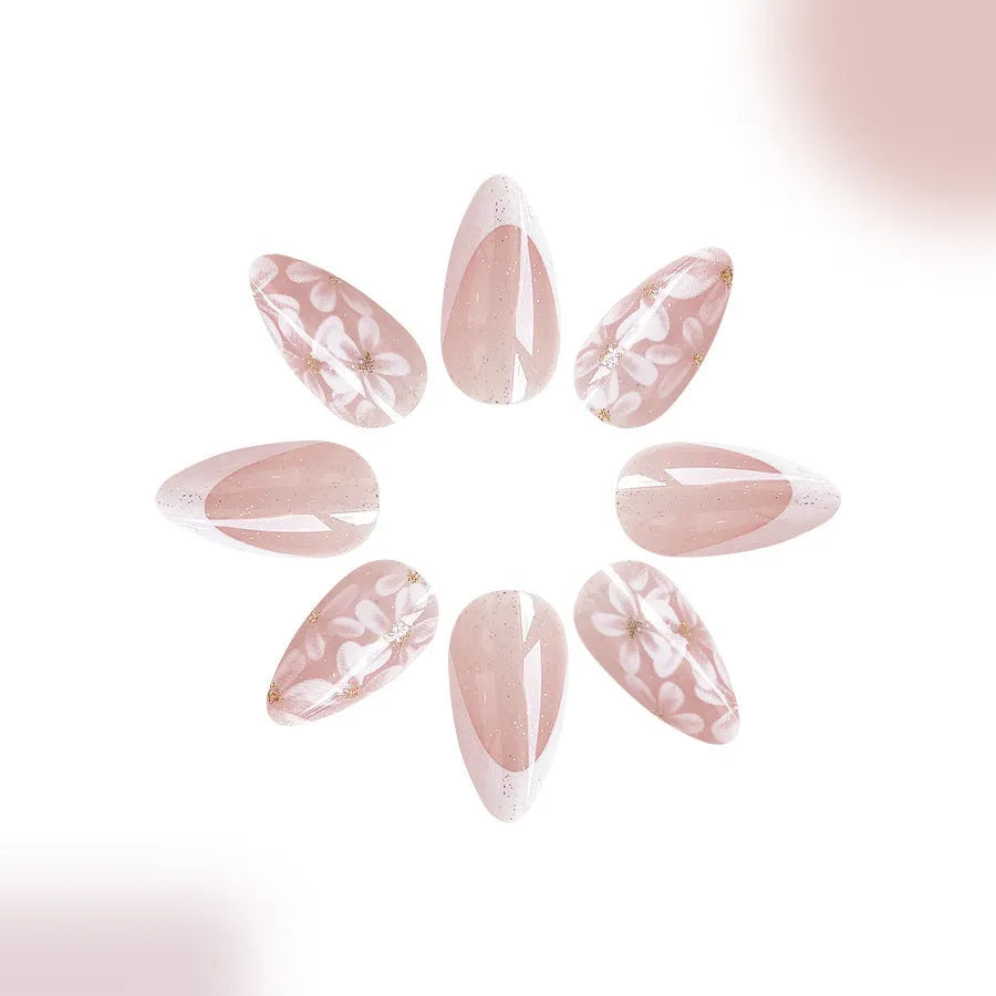 Short almond-shaped glossy French style press-on nails with removable glitter powder flower decorations, colour C625