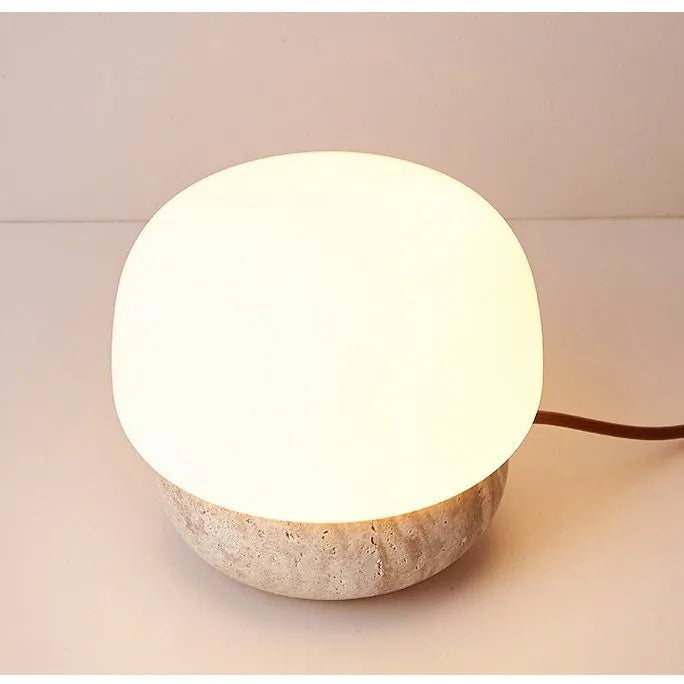 Cream coloured retro bedside lamp with button switch on small table