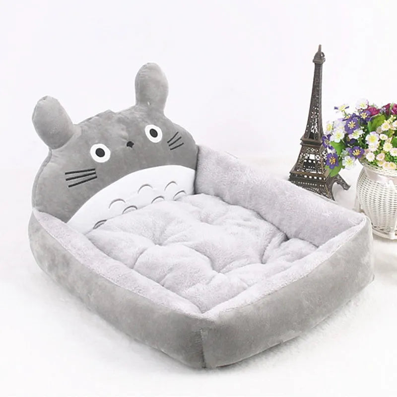 Cartoon print washable pet sofa bed for a small dog or cat, shown in blue, brown, gray, pink, or yellow.