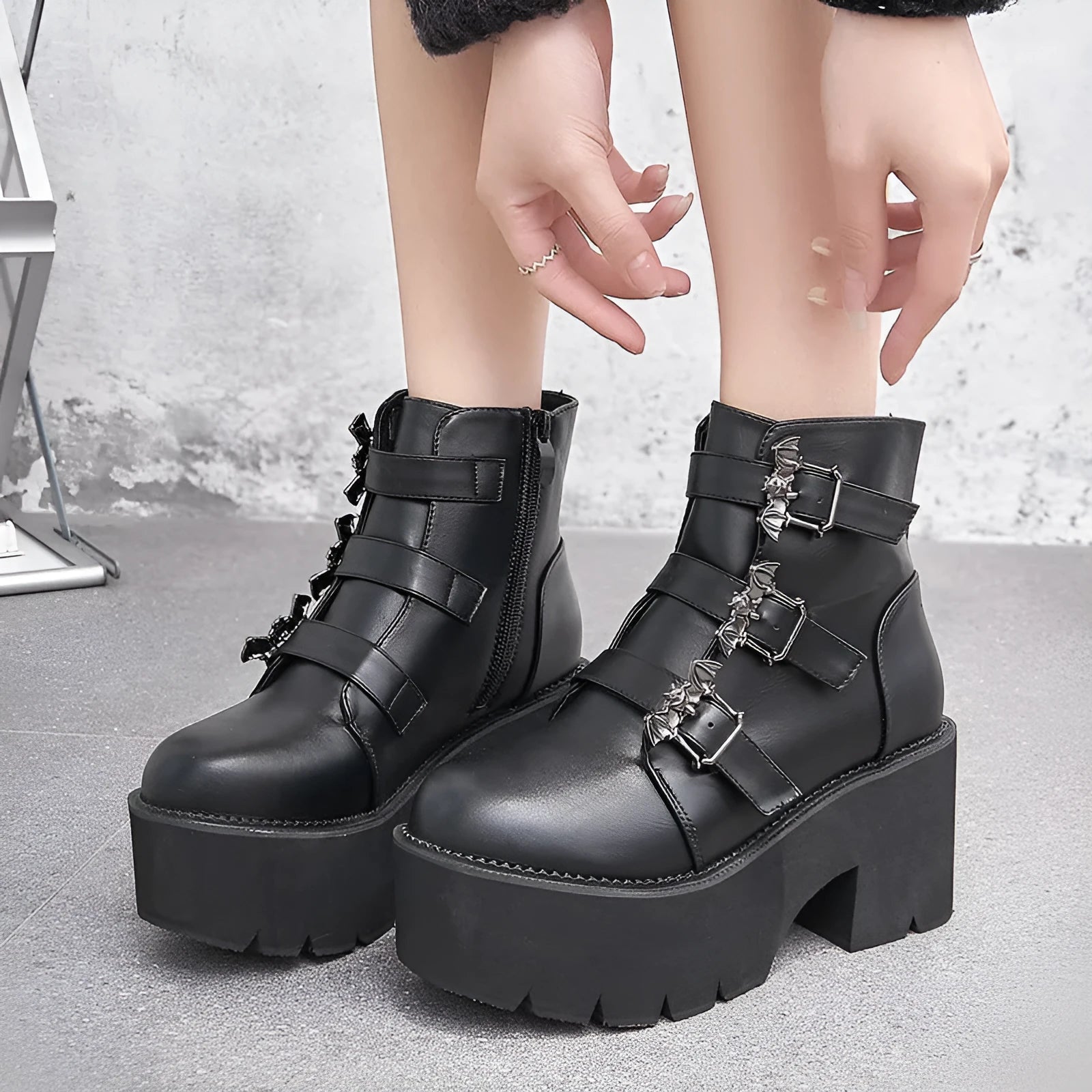 Black women's Harajuku punk ankle boots with a bat-shaped buckle and side zipper.
