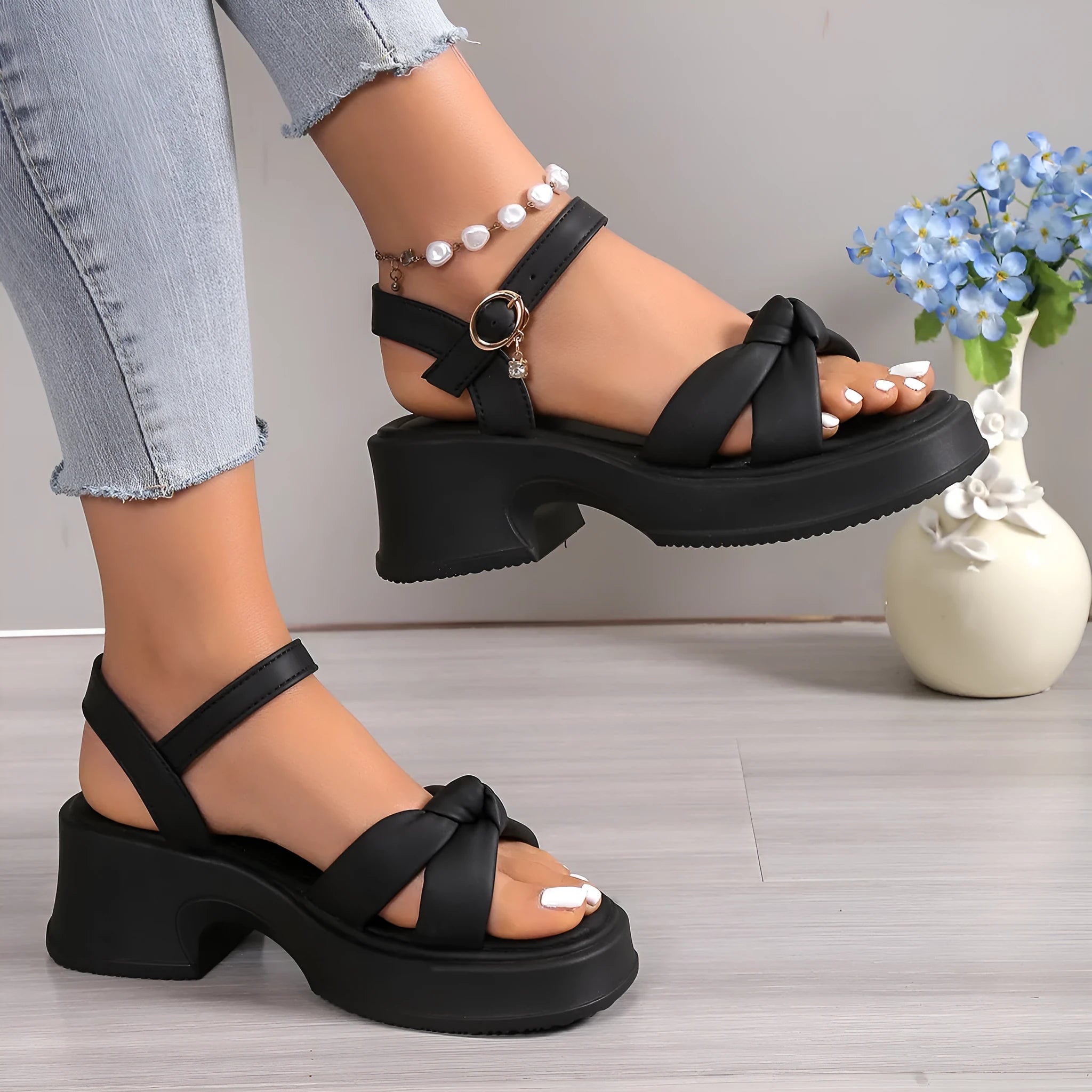 Black women's high heel slippers with thick platform sole and button closure.