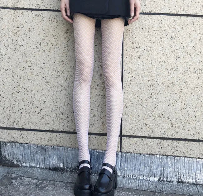Women's black and white mesh stockings showing large, medium and small net patterns on thin velvet fabric