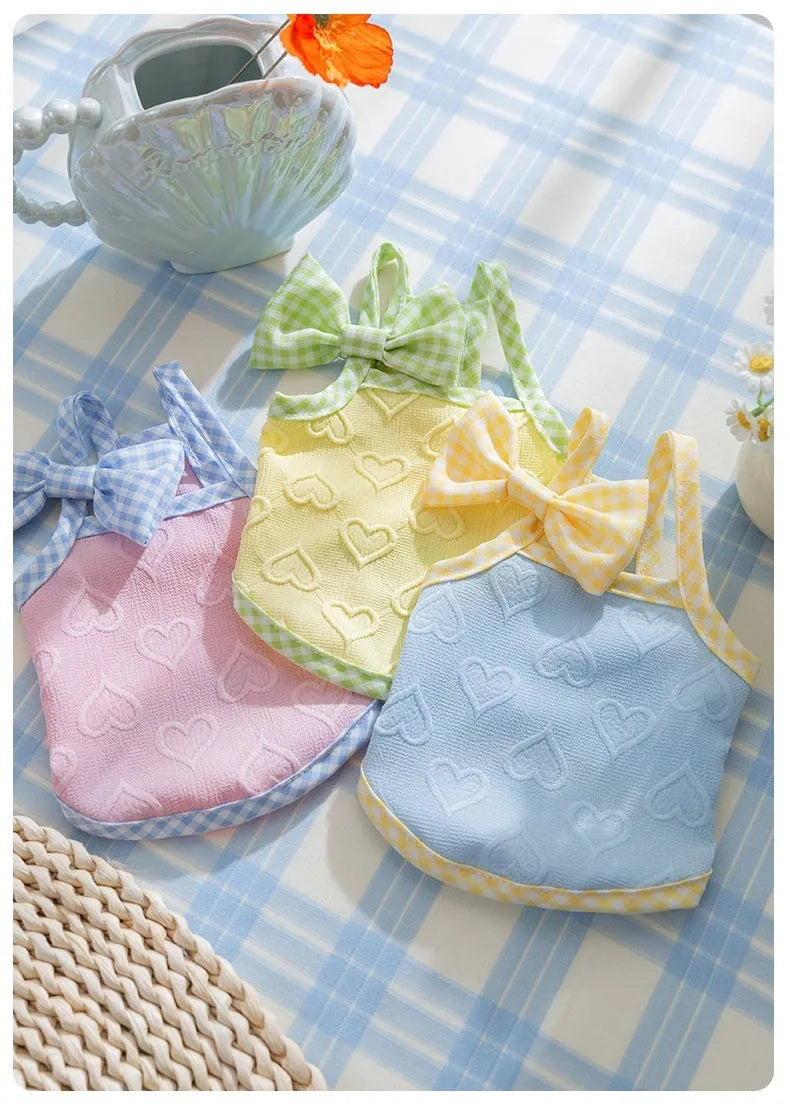 Small dog wearing heart bow suspenders vest with elastic sides in Bondi Blue colour with matching hairband