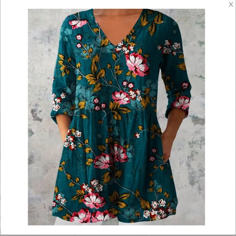Women's printed loose-fitting dress with wide waist and three-quarter length sleeves.