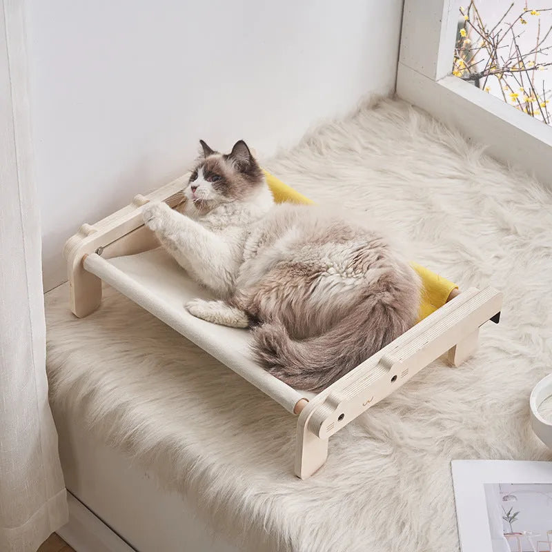 Solid wood pet bed for cats with removable washable cover in black and white plaid pattern on floor