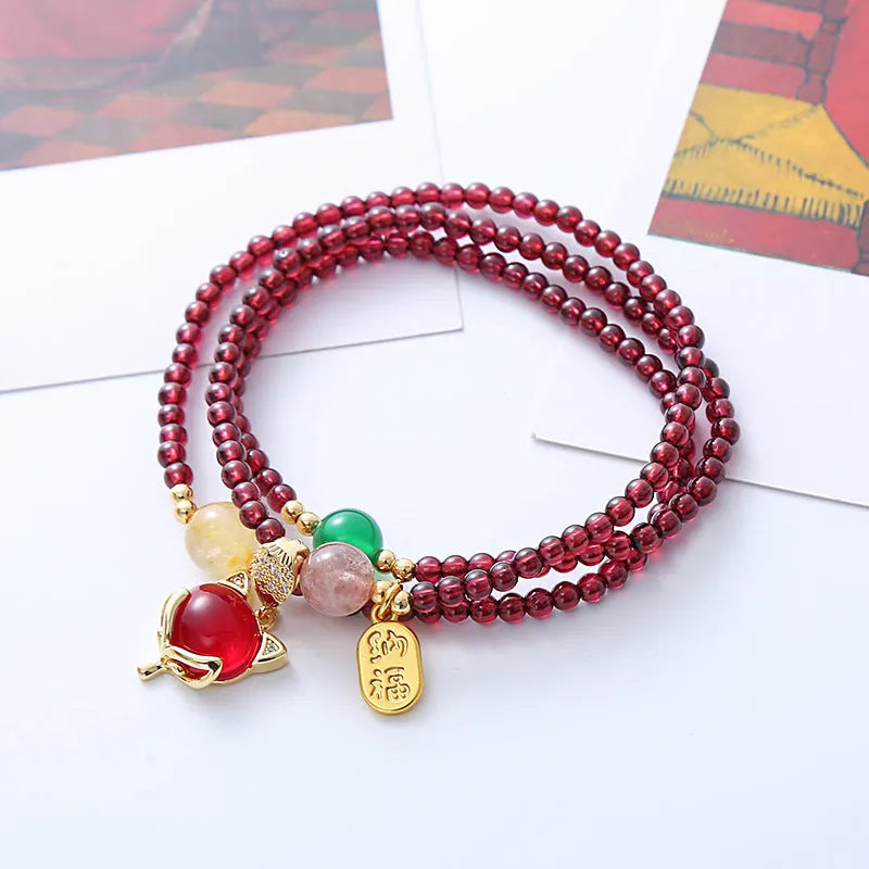 Purplish red garnet crystal bracelet with fox charm and adjustable rope