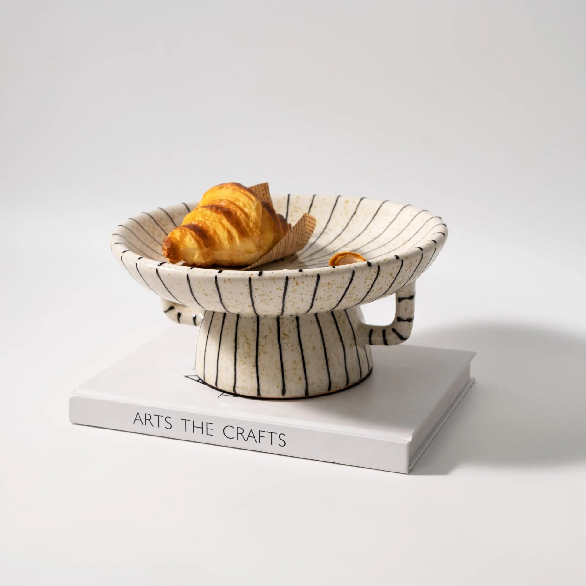 Black and white striped retro resin fruit plate on a table.