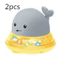 Automatic spray whale bath toy with LED lights floating in water