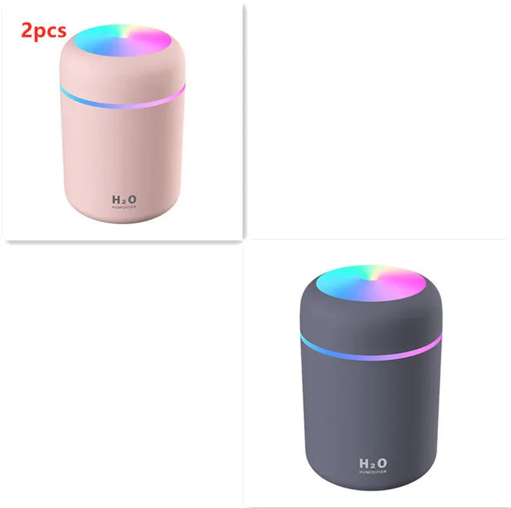 Pink, white, or navy blue USB desktop humidifier with colourful LED lights and water tank.