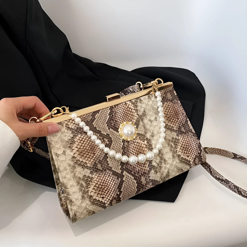 Hard PU evening bag in snake pattern with pearl-chain detail and stitching, available in six colours