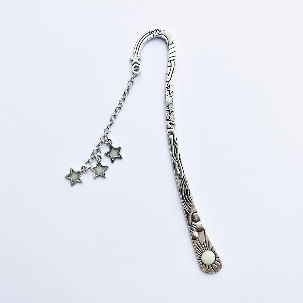 Retro five-pointed star glowing metal bookmark in ancient silver or bronze with sun, moon and stars design
