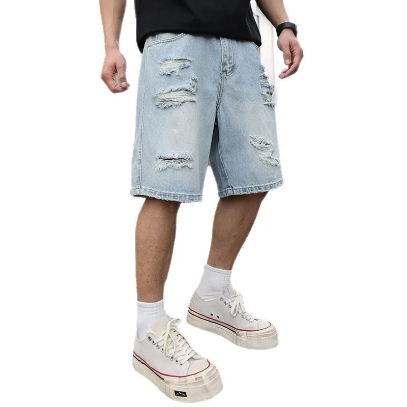 Light blue ripped denim shorts with loose straight-leg cut and distressed detailing on mannequin