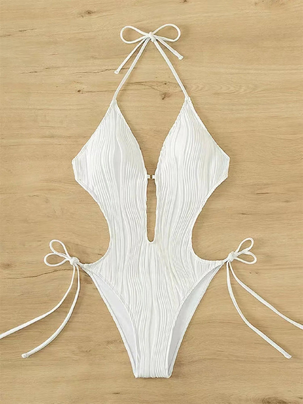 Women's black triangle bikini with lace-up front detail on solid colour background