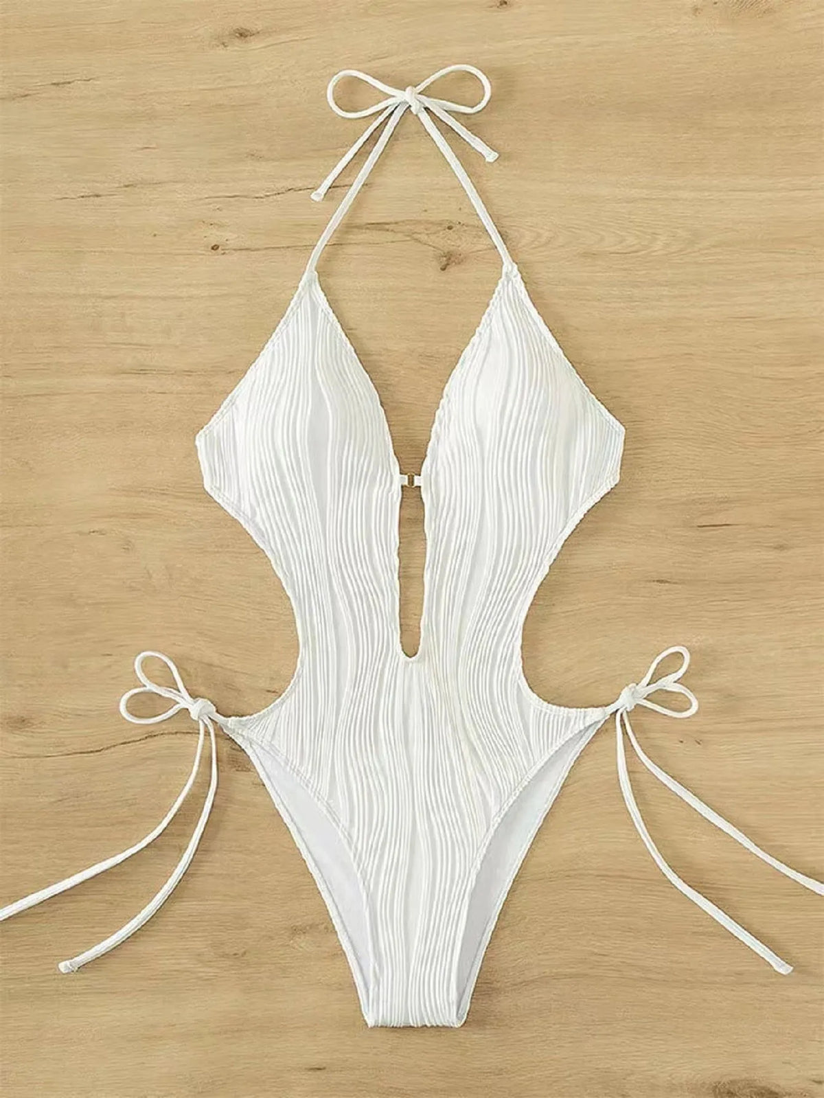 Women's black triangle bikini with lace-up front detail on solid colour background