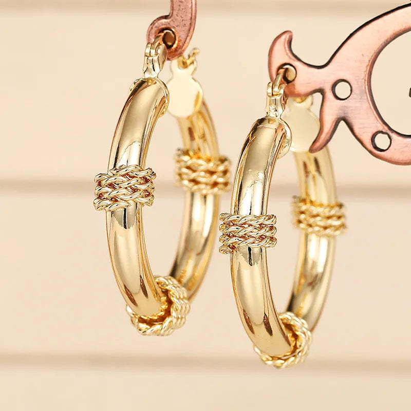 Geometric copper earrings with ring and line design elements in golden finish