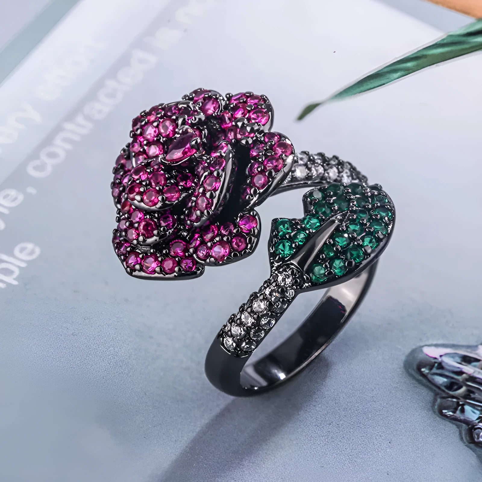 Black gold geometric flower personality ring with red corundum simulation stone on female hand