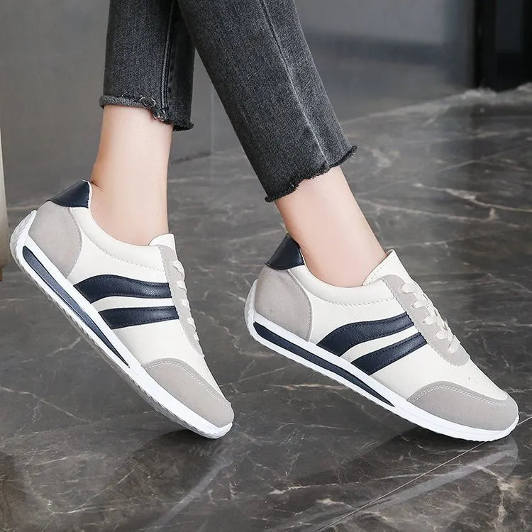 Red and blue low-top lace-up leisure sneakers with round toe and rubber sole.