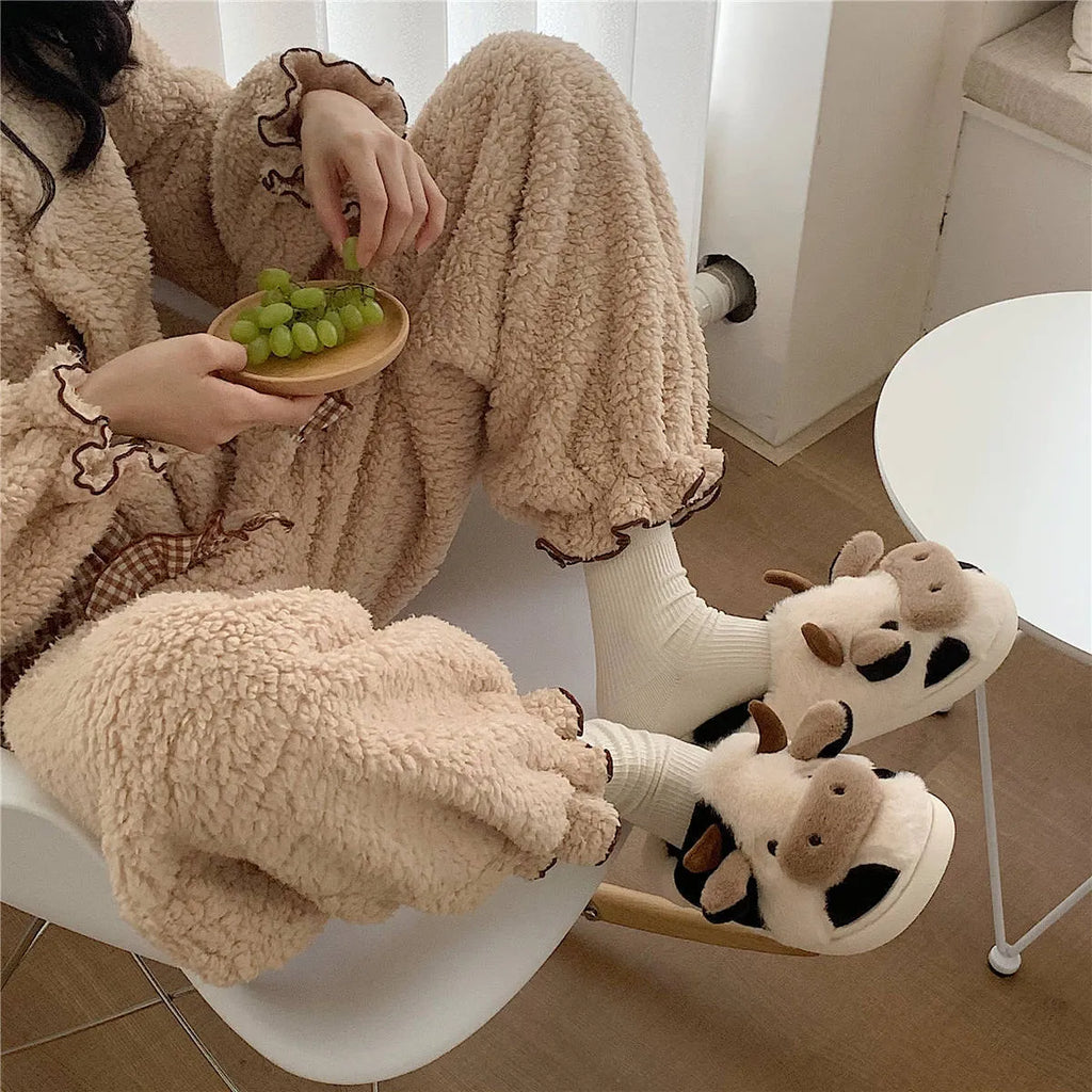 White cow animal house slippers with black spots, plush lining, and textured non-slip sole