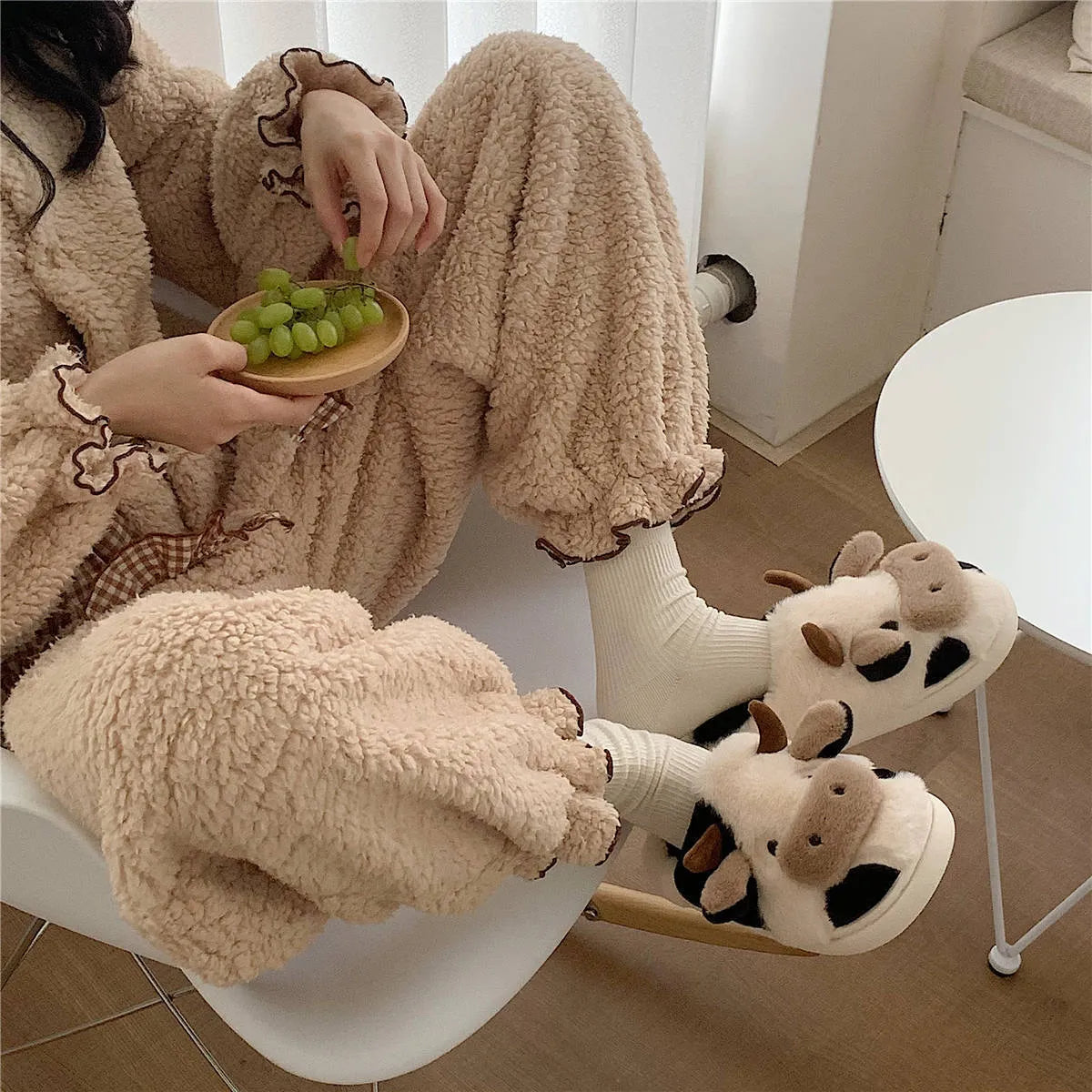 White cow animal house slippers with black spots, plush lining, and textured non-slip sole