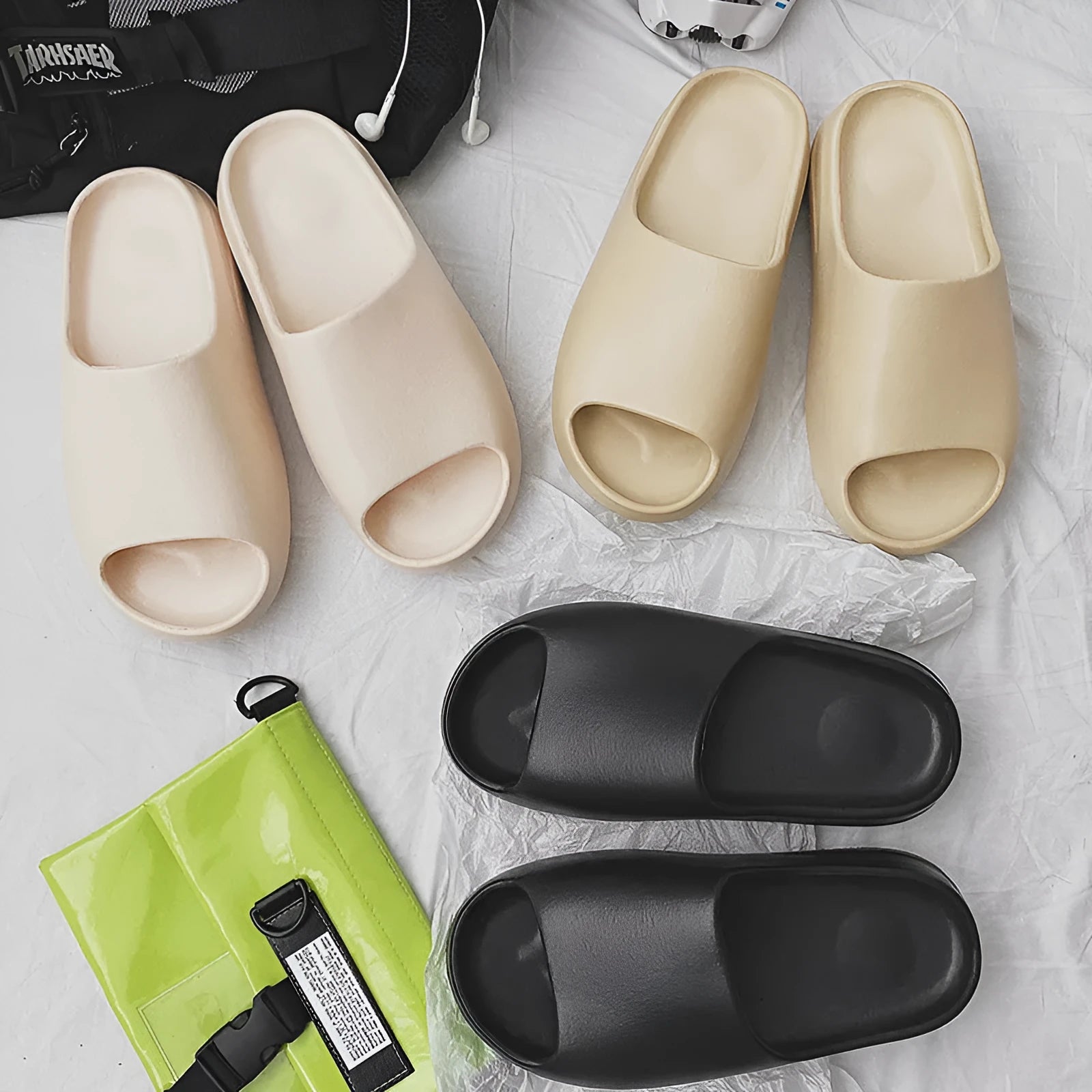 Women's thick sole beach slippers in black, green, and brown colours on a plain background