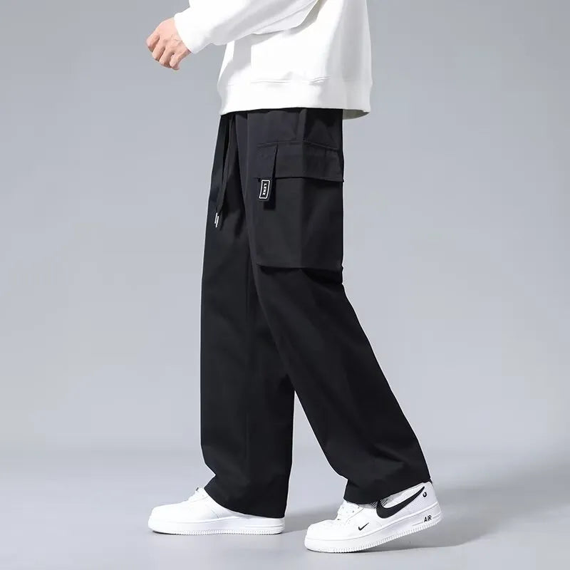 Boys in army green straight leg cargo pants with large pockets and a drawstring waist.