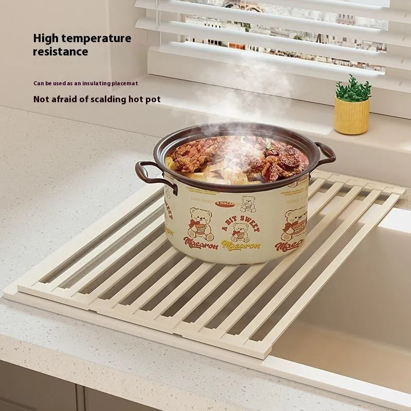 Milky white foldable stainless steel kitchen draining rack over a sink.