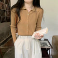Long-sleeved beige viscose knitted cardigan top shown loose fit on a hanger