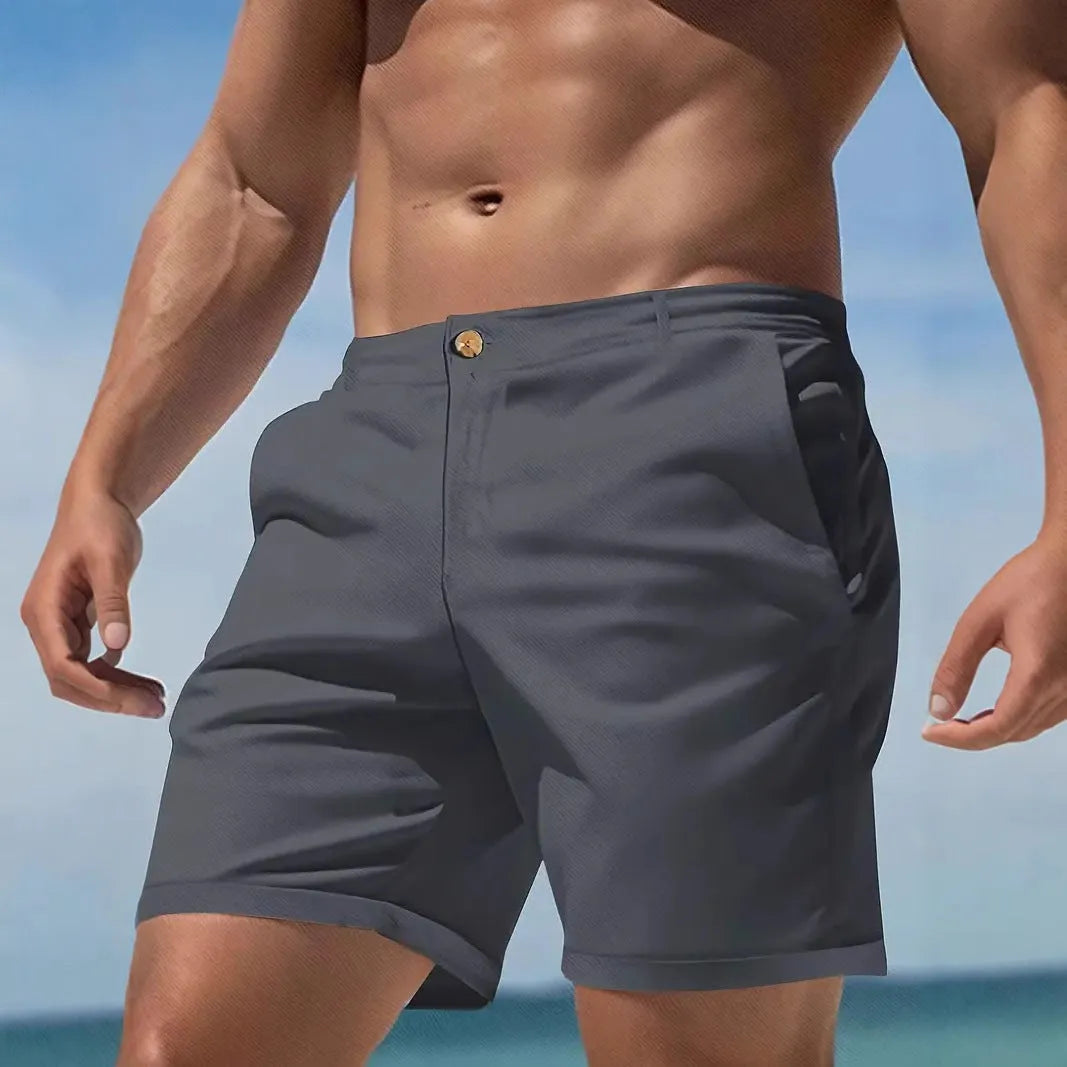 Man wearing solid grey cotton blend straight-leg casual shorts with micro-elastic fabric.
