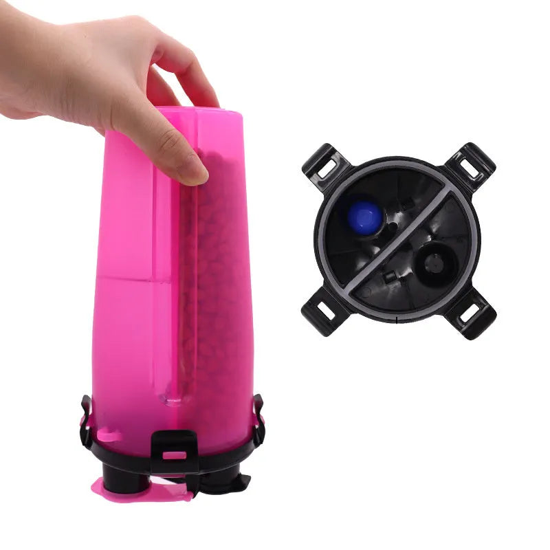 White portable pet water and food cup with bowl attachment on grass.