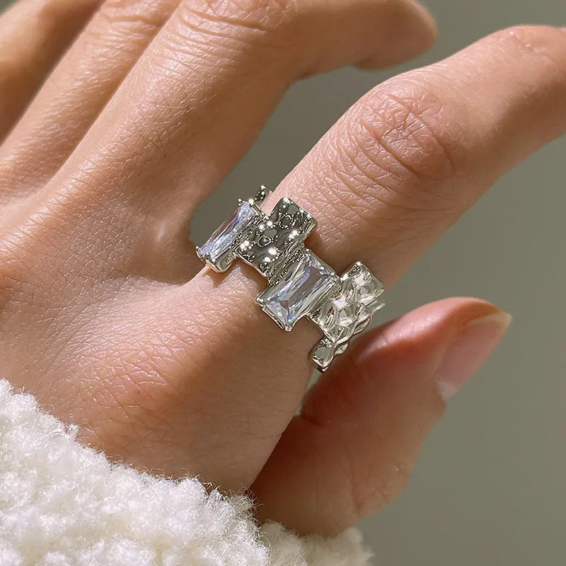 Silver plated open ring with geometric cross zircon and retro design.