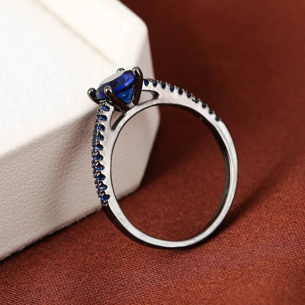 Geometric hexagon zircon fashion ring in electroplated copper on a hand, showing gold and gun black colour options.