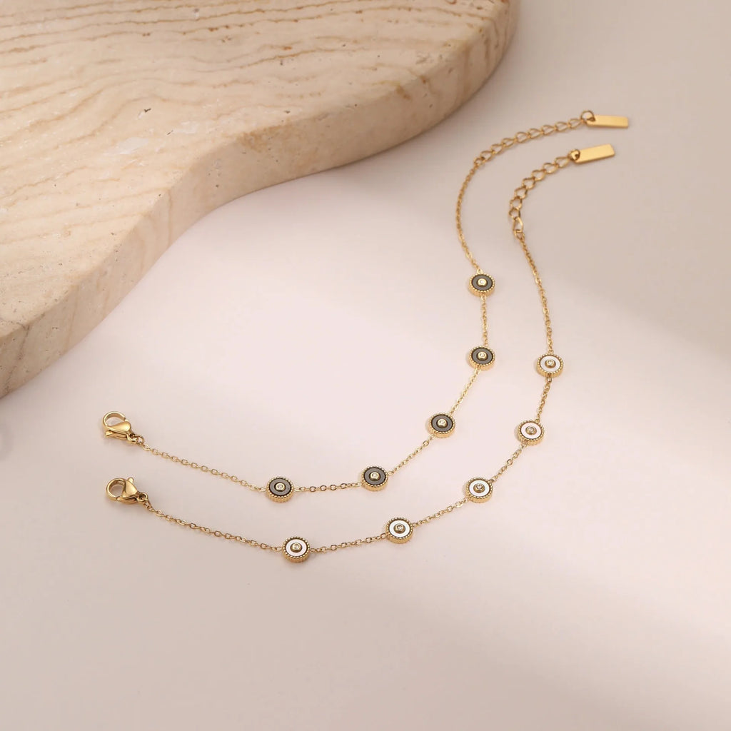 Stainless steel bracelet with 18K gold electroplating and geometric fritillary design, shown with matching necklace