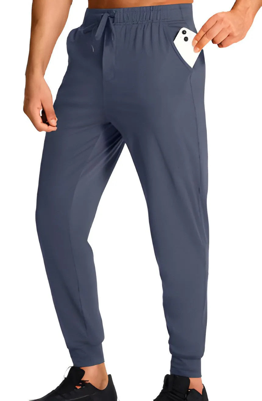 Man wearing loose fit solid colour casual polyester trousers in a leisure setting.
