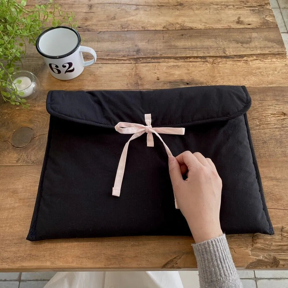 Women's black and white striped quilted computer bag with ballet style bow detail