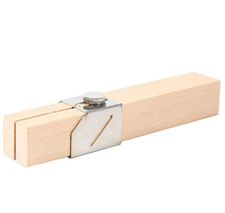 Plastic bottle cutter in log colour on a table showing its compact 2.2cm width and 14cm length