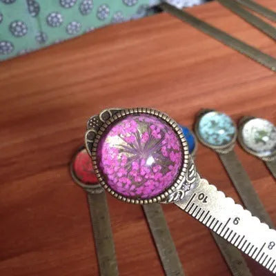 Handmade dried flower ruler bookmark with gypsophila, daffodil, lace flower, and clover on 12cm base in multiple colours.
