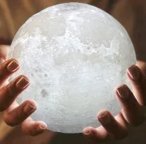3D printed white moon lamp on a wooden stand with touch control ring at base