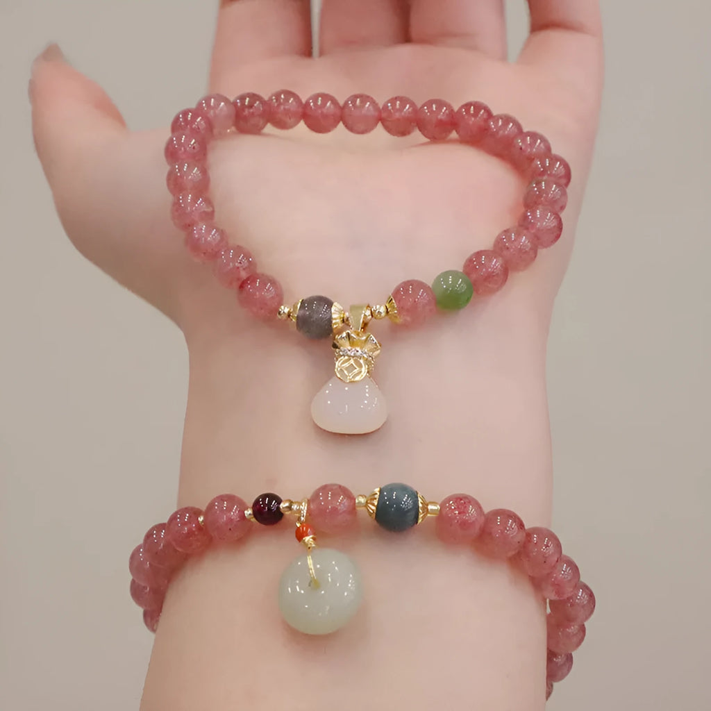 Natural strawberry quartz women's bracelet with purse charm detailing and peace buckle clasp
