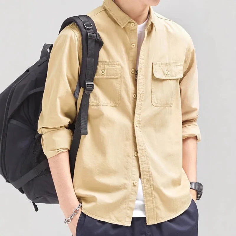 Man wearing a loose-fit light grey polyester cardigan shirt with long sleeves and an overalls design detail.
