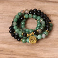Green and black elastic beaded alloy bracelet on wrist showing natural style design