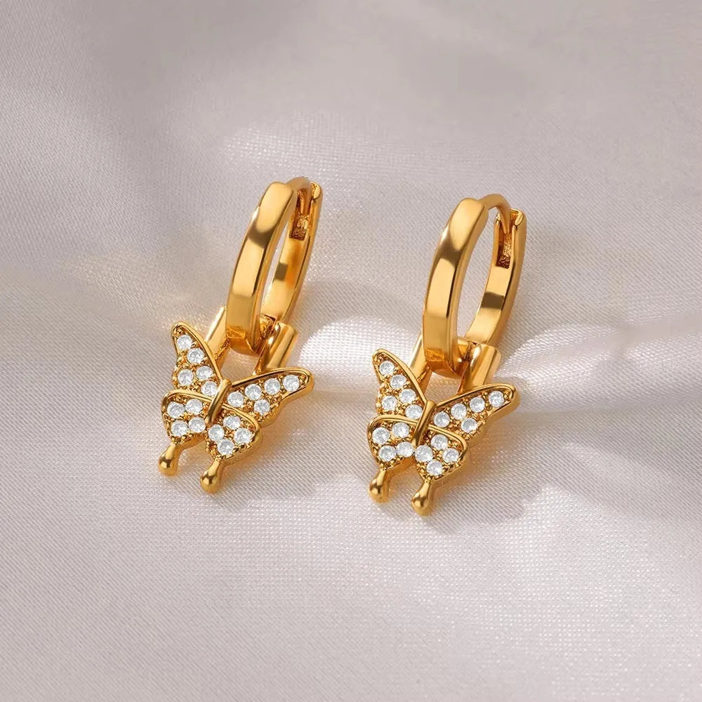 Women's copper butterfly earrings with geometric heart, star, and bow shapes in assorted colours.